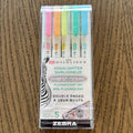 Pack of Zebra highlighters on a wooden surface
